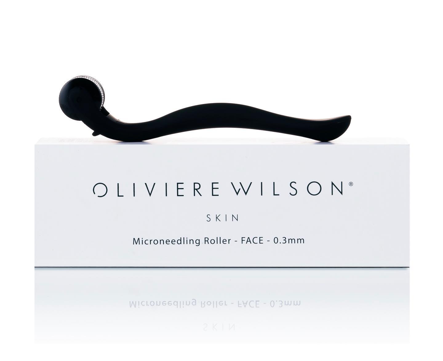 A microneedling roller by Oliviere Wilson for skin, sits on its box, simple studio shot.