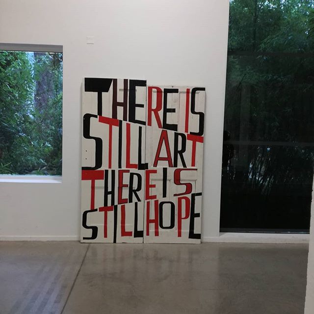 A motivational piece of art in a gallery showcases positive messages in a contemporary style.