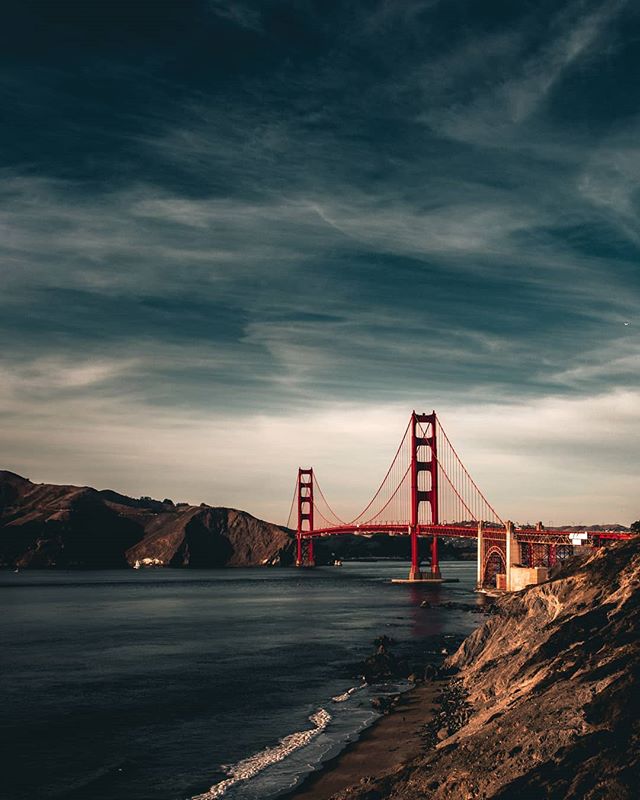 Golden Gate Bridge in San Francisco, California on a clear day with dark blue water.