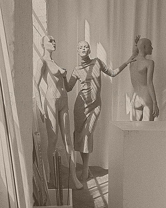 Monochrome studio shot featuring three mannequins in artistic poses, bathed in soft, natural light.