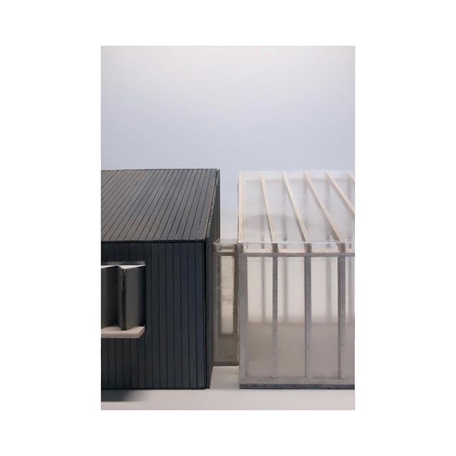 A minimalist architectural model showcasing a modern house design with clean lines and a simple form.