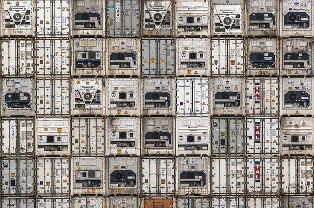 A stack of shipping containers provides a commercial visual for supply chain and global logistics.