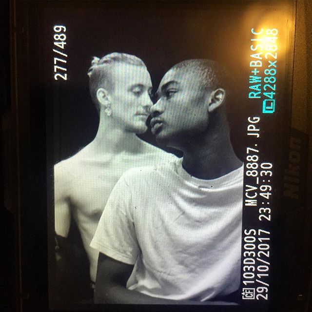 Intimate black and white portrait of two men. Soft lighting and close crop enhances the connection.